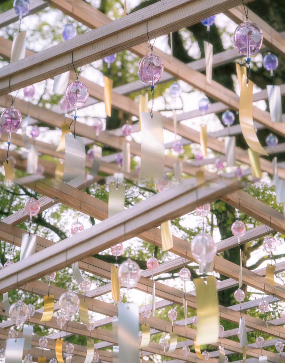 Japanese glass furin wind chimes hanging outdoors in a peaceful garden