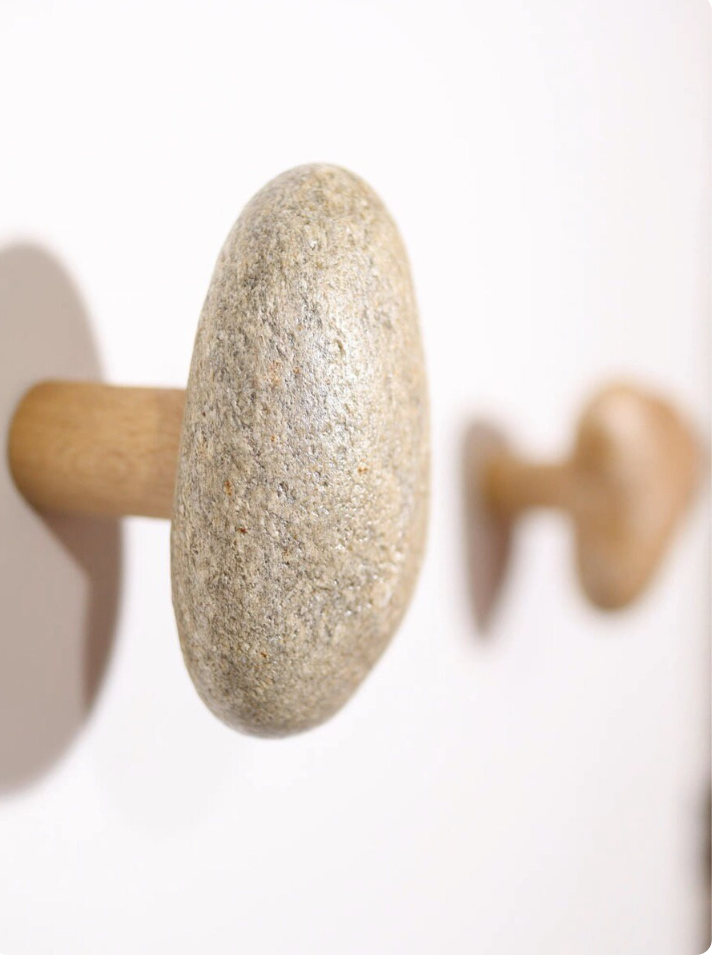 Natural stone wall hooks mounted on a white wall for Japanese-inspired home decor
