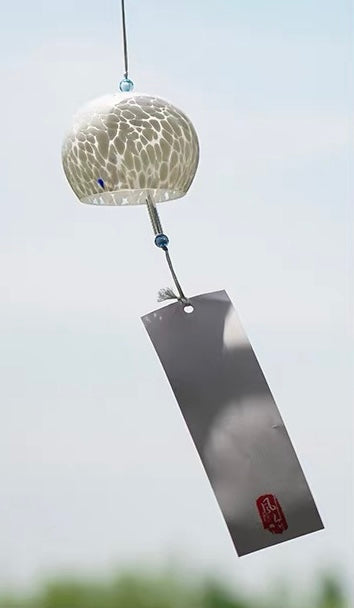 Handcrafted Japanese white round glass furin wind chime with a black tanzaku tag.