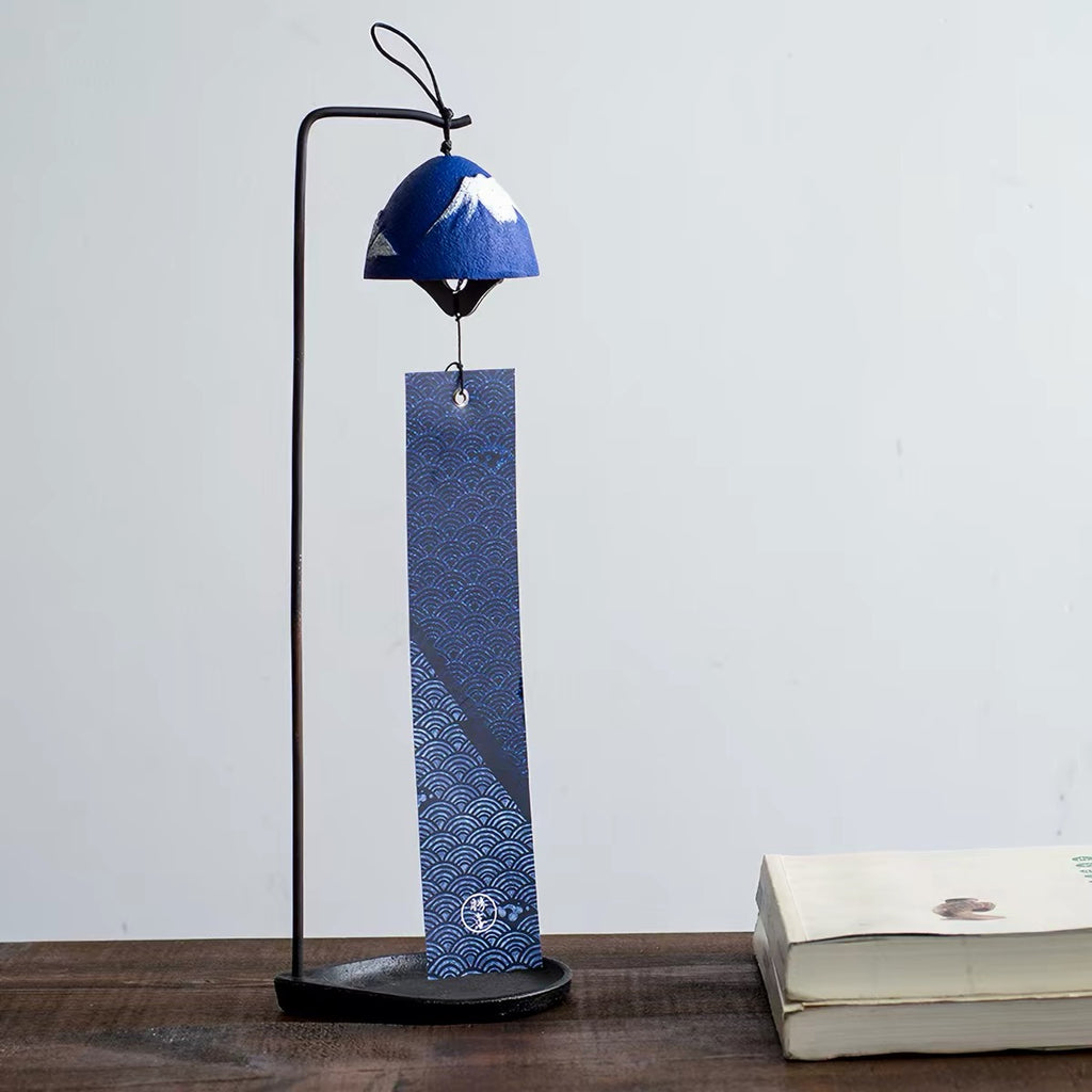 Handcrafted blue Mount Fuji cast iron furin wind chime displayed on a decorative stand for indoor décor.