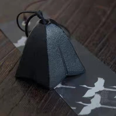 Handcrafted Japanese cast iron gentian flower wind chime displayed on a wooden table.