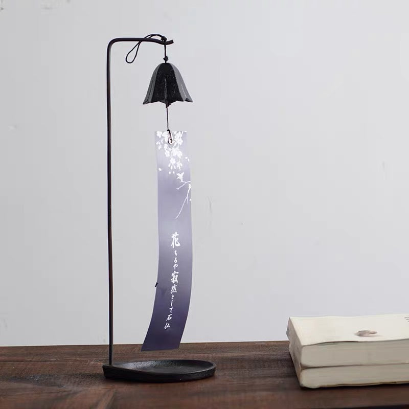 Handcrafted Japanese cast iron gentian flower wind chime displayed on a decorative stand for indoor display.