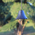 Close-up of a handcrafted Japanese cast iron furin wind chime with an organic leaf-inspired design.