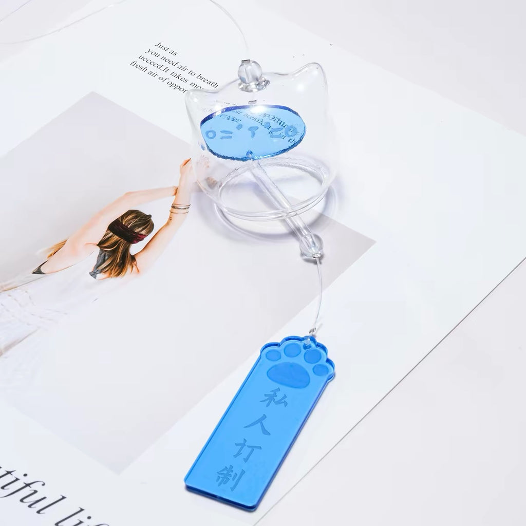 Personalized Japanese glass cat furin wind chime displayed on a tabletop with a custom blue paw-shaped Tanzaku wish tag.