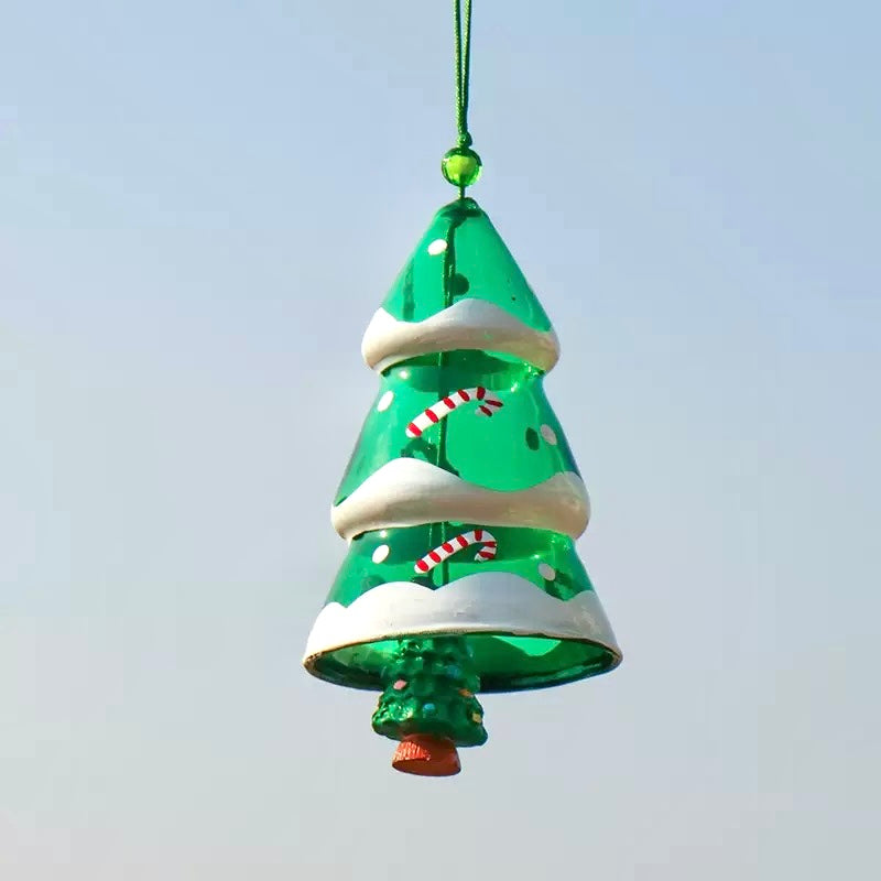 Green Christmas tree glass wind chime with candy cane details hanging against a clear blue sky