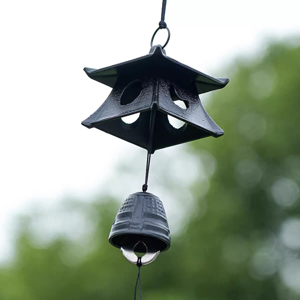 Japanese cast iron temple pagoda furin wind chime hanging outdoors with a black bell