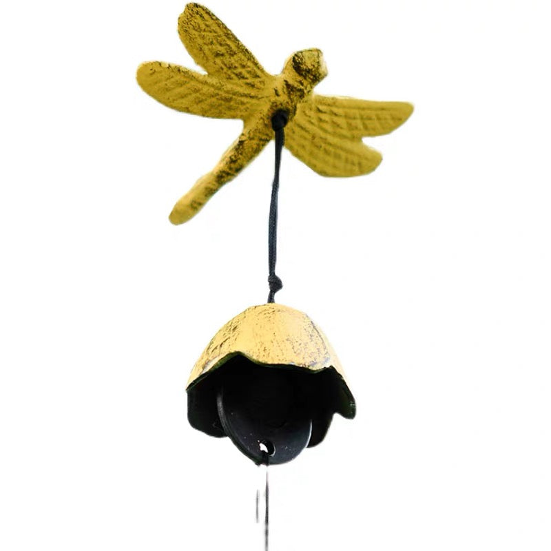 Yellow dragonfly cast iron wind chime with a small bell on a clean white background