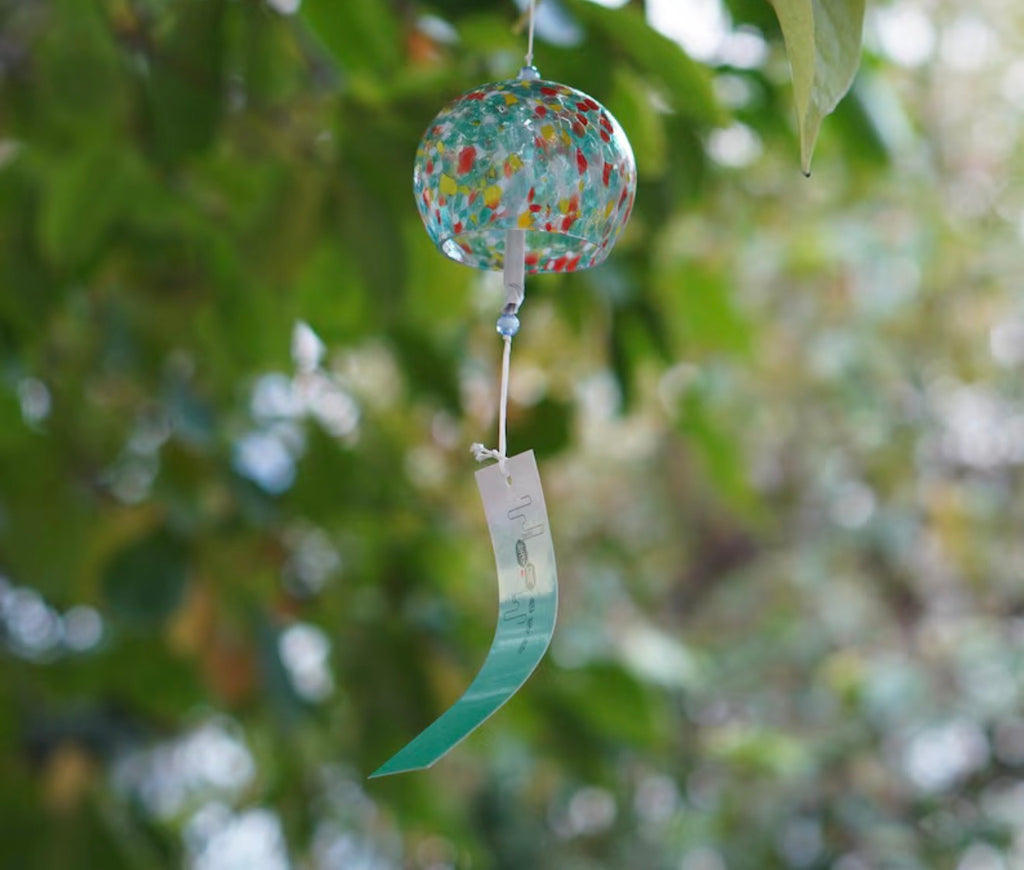 Green and red mosaic Japanese glass furin wind chime hanging outdoors