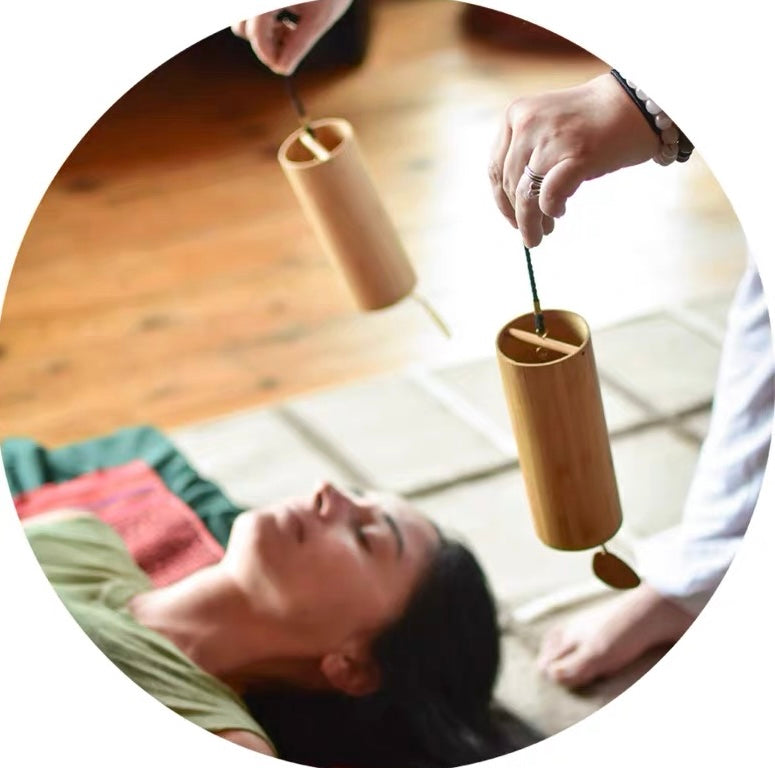 Japanese bamboo meditation wind chimes used during a relaxing sound therapy session for calm and mindfulness.