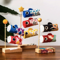 Collection of three handcrafted Japanese koinobori desk decorations featuring blue and red, blue red and yellow, and black and red embroidered carp streamers.